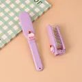 Cute purple folding mini hairbrush with cupcake ornament for portable travel hair care - Cupcake