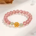 Strawberry quartz beaded bracelet with golden silver lotus charm and green jade accents. - Strawberry Quartz Hetian Jade