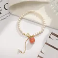 Detailed macro view of freshwater pearl bracelet with carnelian persimmon charm - Persimmon Good Fortune Pearl Bracelet (Premium)