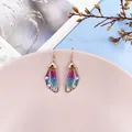 Detail view of colorful gradient cicada wing earrings with sparkling rhinestones - Rose Gold / Rainbow Gradient