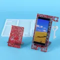 Detailed view of white silicone phone stand mold alongside red glittery resin samples - Large Plate Heart Key Set Mold (60-766) / White / White