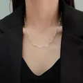 Close-up of sparkling silver paperclip chain necklace on a model in a black blazer - Paperclip Style Necklace