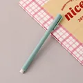 Eternal inkless pencil in mint blue, displayed on a stylish pink checkered notebook - Green / HB