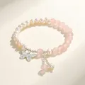 Elegant freshwater pearl and pink crystal bracelet with a detailed silver butterfly charm. - Rose Quartz Freshwater Pearl Butterfly Style