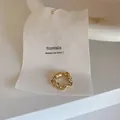 Detailed view of a gold chain-link magnetic ear cuff displayed on a white minimalist tag - Chain / Gold