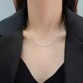 Detailed view of a sparkling silver star Chopin chain necklace worn on a model's neck - Sparkling Wave Style
