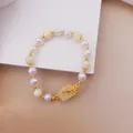 Close-up of cat's eye and pearl beaded bracelet with elegant gold butterfly accent - No. 2 Butterfly Flower