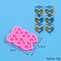 Pink heart-shaped silicone mold for DIY resin earrings with finished blue sample pieces - Nested Hearts Style (50-3039-A)