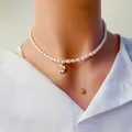Détail du collier de perles d'eau douce avec fleur en zircon et gland doré. - Fleur de Zircone Blanche / Blanc
