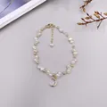 Detailaufnahme eines handgefertigten Barockperlenarmbands mit einem Mondanhänger aus Kristallen - Mond