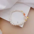 Elegant white pearl beaded bracelet featuring cat-eye rabbit charm and coral bead detail - No. 1 Rabbit