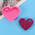 Close-up of heart-shaped silicone mold and a finished glittery resin heart pendant - Heart Style (50-2136-A)