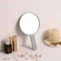 Minimalist grey handheld round makeup mirror perfect for portable and daily vanity use. - Round Mirror / Blue