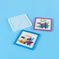 Close-up view of a square silicone mold with finished forest-themed resin coasters - Elk Pattern (60-1040)