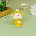 Detail view of cute yellow resin monkey cake topper with dimension markings - Cartoon Resin Monkey