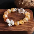 Close-up of a natural citrine bead bracelet with pearl and silver butterfly charm - Yellow Tower Crystal Bowknot Style