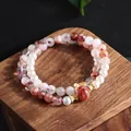 Detailed view of natural red lepidocrocite quartz and pearl multi-layer bracelet - Red Ghost Double Wrap Style