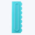 Detail view of turquoise plastic cake scraper comb with scalloped edge for baking. - Fan Pattern Style (84004-17)