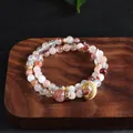 Macro view showing the natural texture of red lepidocrocite quartz and gold spacers - Red Ghost Running Ring Double Wrap