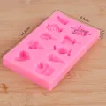Detailed macro view of pink silicone mold featuring lollipop and heart shape cavities. - Cartoon Snacks Mix (50-1901 Pink)