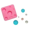 Detail shot of pink silicone mold with circular cavities and colorful sample spheres. - Y-13 Style (Y-13) / Pink