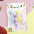 Detail view of colorful heart-shaped spiral birthday candles in retail blister pack packaging. - Spiral Rotating Heart Style