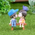 Close-up of cute cartoon couple figurines sitting on a bench for micro landscape decor - Blue And Pink Couple With Bench Set