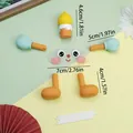 DIY cartoon character LED cake topper kit with dimensions in orange and teal. - Soft Rubber Cartoon Smile Decoration / Set of 6