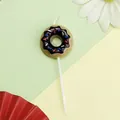 Bougie d'anniversaire en forme de donut avec glaçage au chocolat et pépites colorées - Donut / Noir