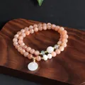 Close-up of natural sunstone double-strand bracelet with white jade pendant. - Peace Buckle Double Bracelet (TA-BR-965) / Orange Pink (Sunstone)