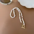 Detailed macro view of white baroque freshwater pearl necklace with gold OT toggle clasp - Baroque Freshwater Pearl Necklace / Single Piece / White