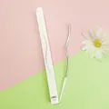 Close-up detail showing a silver curved birthday candle and minimalist white packaging - 1 Piece / Silver