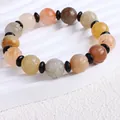 Nahaufnahme eines natürlichen Xinjiang Goldseiden-Jade-Armbands mit Kürbisperlen im Ethno-Stil - Lotus Bead (12mm)