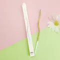 Detailed view of a gold curved birthday candle and its minimalist white packaging box. - 1 Piece / Gold