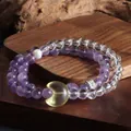 Vue détaillée d'un bracelet double en améthyste et cristal avec pendentif lune jaune - Pendentif Lune