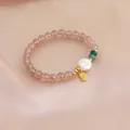 Close-up detail of natural strawberry quartz bracelet with white pearl and golden Fu charm - Baroque Pearl and Fu Charm Style