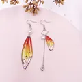 Elegante asymmetrische orangefarbene Zikadenflügel-Ohrringe mit Perlen und Herzquaste - Orange Strass-Silber