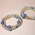 Close-up of handmade natural blue kyanite and crystal beaded bracelets on a textured background. - Kyanite & Yellow Citrine Style / Split Ring