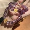 Detailed close-up showing the lavender purple and golden yellow beads of the crystal bracelet - Lavender Purple Azeztulite