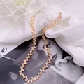 Macro view of pink rice-shaped freshwater pearl necklace with elegant petal design - Pink Necklace