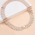 Detailed macro view of a rose gold wide mesh chain necklace in punk hip-hop style. - Rose Gold