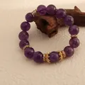 Close-up of natural Uruguay amethyst bracelet with gold crown charms - Uruguay Amethyst (12mm) / 12mm / Purple