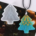 Detail view of a Christmas tree silicone mold and its finished teal resin pendant. - 60-910 White (Christmas Tree)