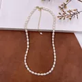 Close-up view of vintage natural baroque pearl necklace with gold adjustable chain - Oblong Pearl Necklace / Natural Pearl Color