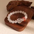 Detailed view of clear crystal beaded bracelet featuring a carved nine-tailed fox charm - White Ghost