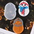 Detail view of snowman silicone mold and finished resin pendants on a Christmas tree. - 60-912 White (Snowman with Scarf)