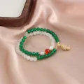 Elegant double-strand beaded bracelet with green/white gemstones and a gold charm - Cute Buddha Pendant Style (TA-BR-491) / Green And White Multicolor