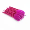 Detailed view of high-quality bright pink disposable eyelash brushes in a large bundle - Rose Red