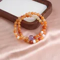 Exquisite detail of double-loop orange jade bracelet with purple amethyst and white pearls - Double Loop Style / Light Golden Silk Jade