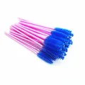 Close-up view of disposable eyelash brushes with pink handles and vibrant blue bristles - Blue